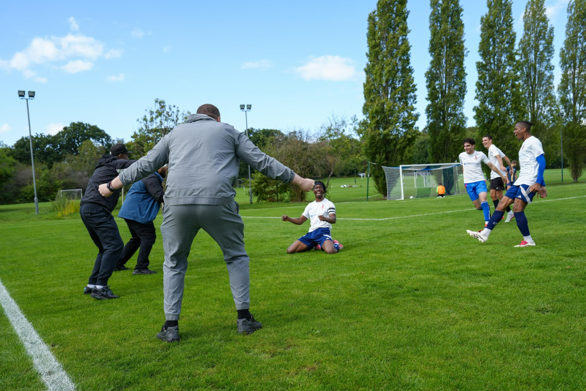 Old Lyonians players celebrating on the touchline